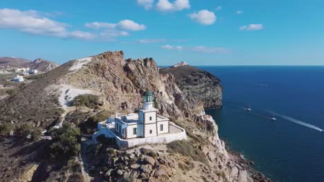 4k-aerial-drone-view-of-beautiful-lighthouse-Santorini-Greece-blue-sky-with-clouds