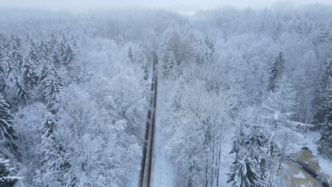 Aerial-Drone-View-Of-Road-In-Idyllic-Winter-Landscape---aerial-pullback