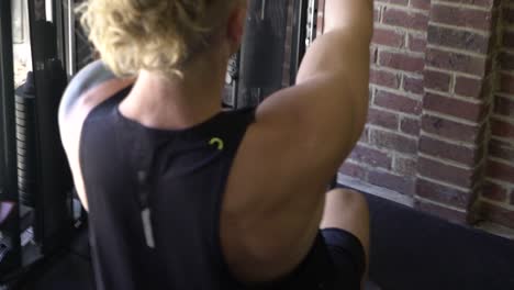 Muscly-man-in-home-gym-exercising-lat-pull