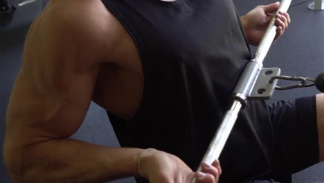 Muscly-man-in-home-gym-exercising-lat-row-big-biceps