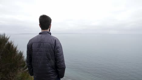 Man-stoically-gazes-out-into-the-Pacific-Ocean
