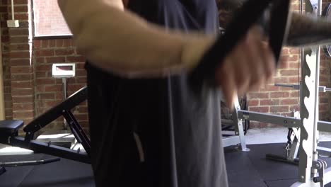 Muscly-man-in-home-gym-exercising-blurry-doing-cable-lat-pull