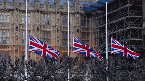 Palace-of-Westminster-Union-Jacks-flying-at-half-mast-to-mark-the-death-of-Prince-Philip,-Duke-of-Edinburgh,-Saturday-April-10th,-2021---London-UK