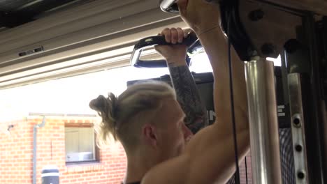 Muscly-man-in-home-gym-exercising-chin-ups-back-workout