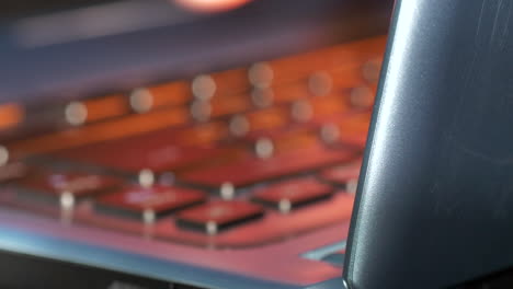 Extreme-close-up-of-laptop-keyboard-and-fingers-typing-on-keys-in-low-lighting