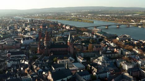 Slow-drone-shot-around-Mainz-the-red-Cathedral-church-in-the-middle-of-the-old-town-with-the-Rhine-river-in-the-back