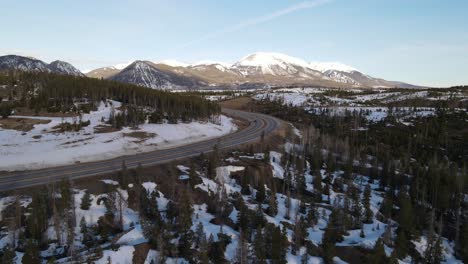 4K-drone-video-reveal-of-cars-driving-in-Rocky-Mountains-during-winter-in-Colorado