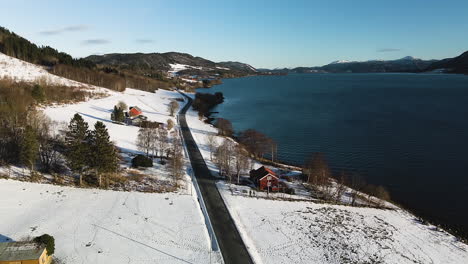 Coastal-Road-Surrounded-With-Snowy-Landscape-During-Winter-In-Norway