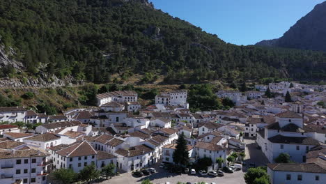 AERIAL---The-village-of-Grazalema-in-Cadiz,-Andalusia,-Spain,-wide-shot-rising