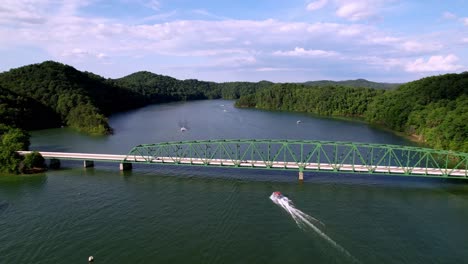 Boat-Passes-under-421-Bridge-on-South-Holston-Lake-near-Bristol-Virginia,-Tennessee-near-Johnson-City-Tennessee,-Mountain-City-Tennessee,-Kingsport-Tennessee-not-far-from-Watauga-lake-Tennessee