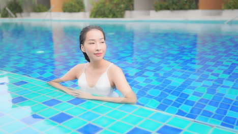 Sexy-Exotic-Woman-Enjoying-in-Water-of-Blue-Swimming-Pool-on-Luxury-Vacation,-Full-Frame-Slow-Motion