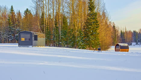 Day-timelapse-of-thermowood-cabin-house-and-sauna-on-wild-winter-woodland