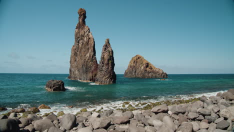Pebble-Beach-and-Volcanic-Rock-Formations-at-Ilheus-da-Rib,-Ribeira-da-Janela,-Madeira,-Portugal---tilt-up-shot