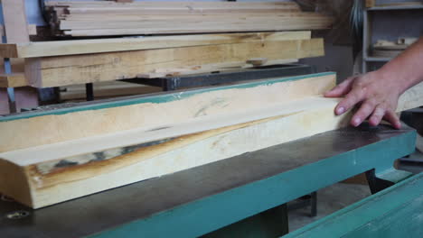 Man-cutting-wood-with-power-saw