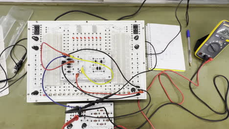 Electronic-Engineering-Workspace-With-Breadboard,-Leads-And-Multimeter