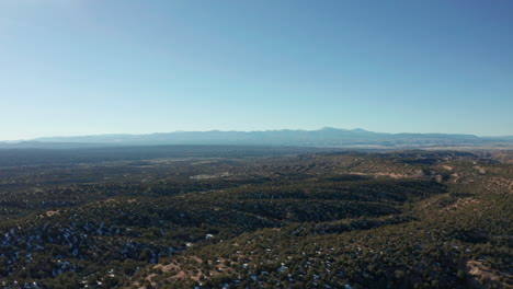 Wide-landscape-aerial-moving-across-winter-desert-landscape-in-daytime,-4K