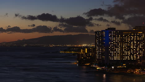 High-rise-Hotels-Illuminated-At-Night-In-Waikiki,-Honolulu,-Hawaii
