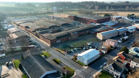 Rising-aerial-pullback-reveals-small-town-with-manufacturing-plant