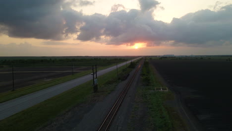 Aerial-Shot-Over-Empty-Railroad-Tracks-At-Sunset-In-Texas,-U