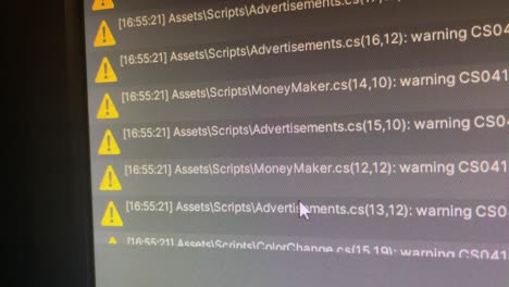 Close-up-of-monitor-displaying-errors-and-warnings-in-Unity-game-engine-for-programming-and-coding---errors-in-script-in-different-program-files-for-code