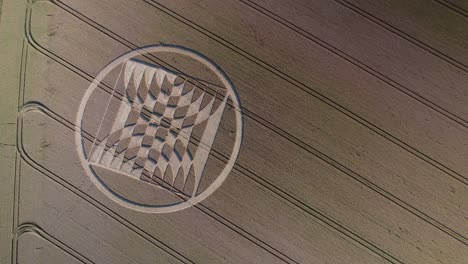 Drone-aerial-footage-showing-fake-UFO-crop-circles-on-a-field-of-grain-near-Micheldever-Station,-United-Kingdom