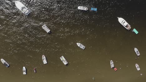 Boats-in-Lake-Michigan-located-in-Muskegon,-Michigan-with-drone-video-from-above-moving-sideways