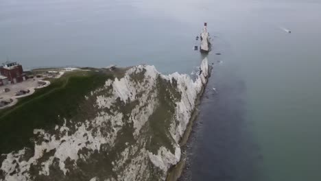 4k-30fps-Aerial-drone-flight-over-the-white-cliffs-at-the-Needles-in-the-Isle-of-Wight-showing-the-red-and-white-lighthouse-out-at-sea
