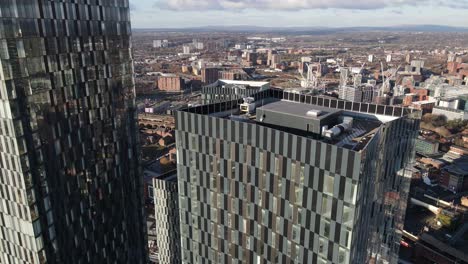 4K-60FPS-Aerial-drone-flight-overlooking-the-rooftop-of-South-Tower-on-Deansgate-in-Manchester-City-Centre-with-the-Hilton-Hotel-and-GMEX-building-in-the-background