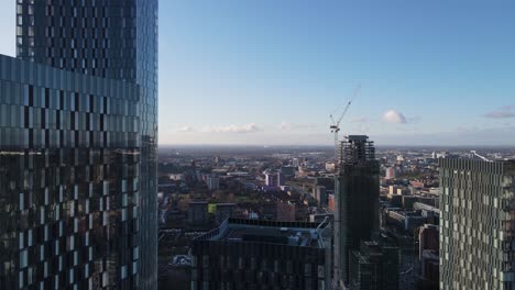 4K-60FPS-Aerial-drone-flight-over-and-between-four-of-the-South-Towers-and-a-tower-under-construction-in-Manchester-City-Centre-on-a-bright-sunny-day