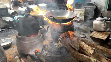 The-process-of-cooking-fried-foods-such-as-tofu,-tempeh-in-a-traditional-skillet-and-stove-using-coals-and-a-stove-1