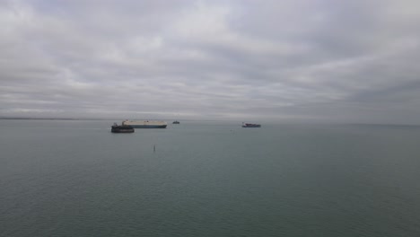 4k-30fps-Aerial-drone-flight-passing-The-Sol-Fort-heading-towards-two-container-ships-heading-out-to-sea-in-the-Isle-of-Wight