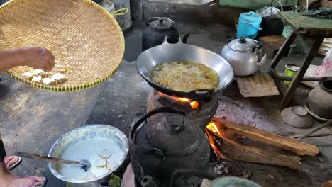 The-process-of-cooking-fried-foods-such-as-tofu,-tempeh-in-a-traditional-skillet-and-stove-using-coals-and-a-stove-3