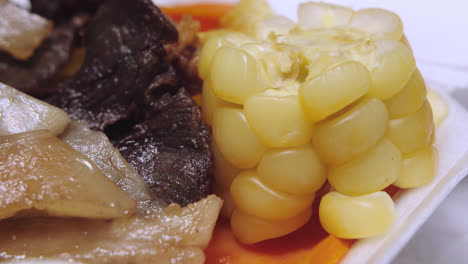 Close-up-of-"maiz-Peruano"-or-"elote"-in-a-"Carne-Seca"-dish
