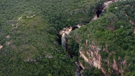 Aerial-drone-wide-shot-of-the-incredible-Mosquito-Falls-surrounded-by-tropical-jungle-and-cliffs-in-the-Chapada-Diamantina-National-Park-in-Northeastern-Brazil-on-a-warm-sunny-summer-day
