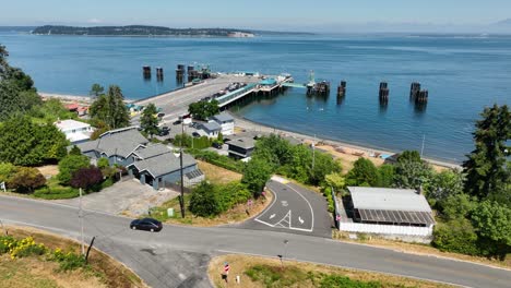 Aerial-shot-of-car-leaving-the-Clinton-Ferry-loading-dock-on-Whidbey-Island