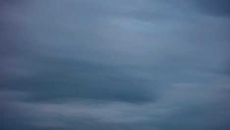 Timelapse-shot-of-dark-clouds-passing-by-high-during-evening-time