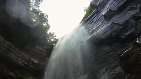 Beautiful-rotating-slow-motion-action-camera-shot-from-under-the-stunning-Mosquito-Waterfall-looking-up-in-the-Chapada-Diamantina-National-Park-in-Northeastern-Brazil-with-water-on-the-lens