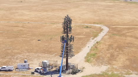 Repairing-or-doing-maintenance-on-a-5G-cellular-tower---orbiting-aerial-parallax