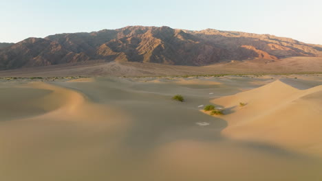 Sand-Dunes-In-Desert-At-Sunrise-In-Death-Valley,-California,-USA---aerial-drone-shot