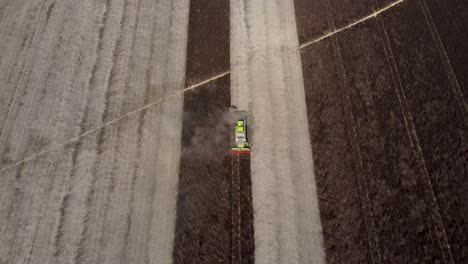 An-aerial-tracking-shot-of-a-combine-harvester-during-a-feed-bean-harvest