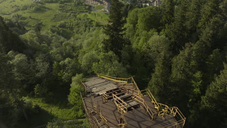 Slowly-Broken-Down-Ski-Jump-Surrounded-With-Lush-Trees-In-The-Forest-Mountains-Of-Bakuriani-In-Georgia