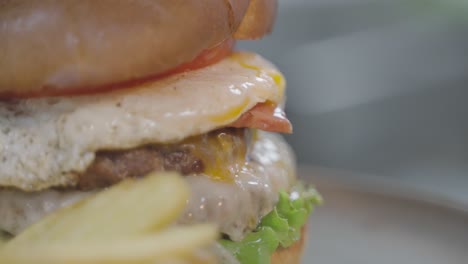 Tasty-beef-burger-with-egg-in-close-up-with-copy-space-for-text