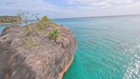 Fpv-aerial-flight-over-rocky-coastline-and-turquoise-water-of-Caribbean-Sea