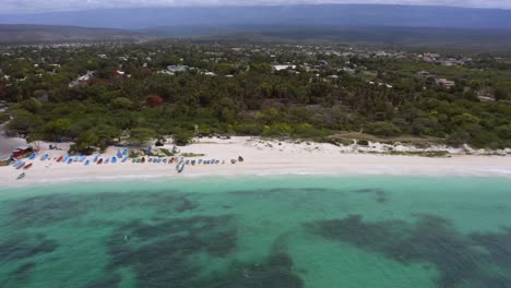 Aerial-trucking-shot-of-coral-reef,-sandy-beach-and-idyllic-landscape-lighting-in-sun---Pedernales-Beach,Dominican-Republic