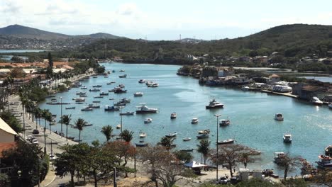 Fishing-boats-and-yachts-moored-at-calm-waters-of-Araruama-lagoon-channel-in-Cabo-Frio,-Brazil
