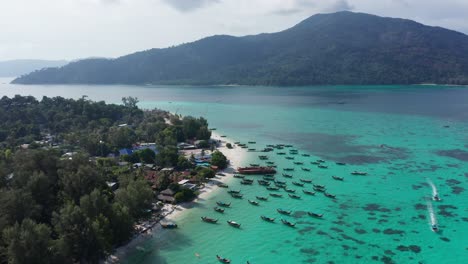 Aerial-of-boats-at-Koh-Lipe-with-Koh-Adang-in-background,-Thailand