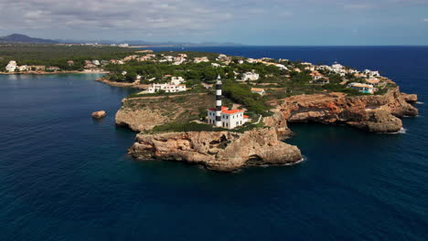 Slow-aerial-orbit-of-lighthouse-on-peninsula-in-Mallorca