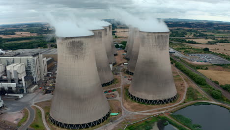 Cinematic-drone-shot-through-clouds-coming-from-Power-Station-Cooling-towers
