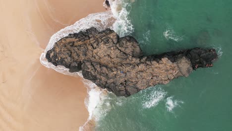 Drone-over-a-large-rock-in-Hawaii-on-the-beach