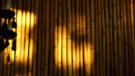 Warm-golden-light-moving-on-bamboo-wall-construction-in-oriental-asiatic-eastern-style